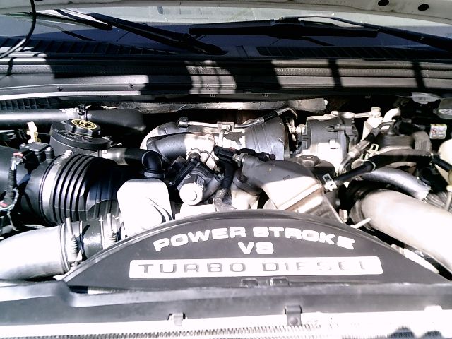 Ford F-250 engine bay with Power Stroke V8 Turbo Diesel label on the engine cover.