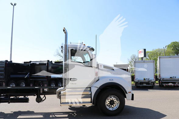 Kenworth T880 cab and chassis truck side profile showing front fender, chrome exhaust stack, and wheel with hubcap.