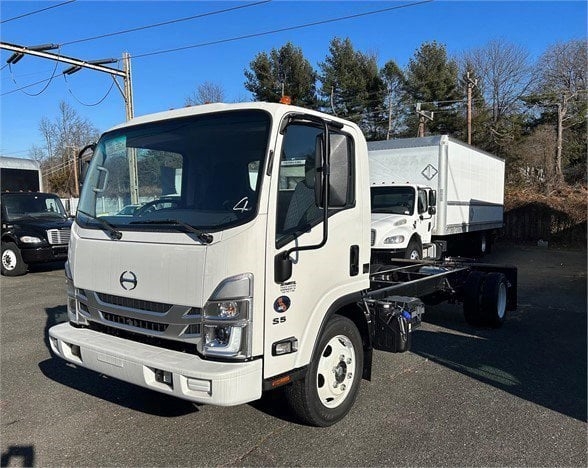 Hino S5 cab chassis truck in white showing front grille, windshield, side mirrors, and chassis behind cab.