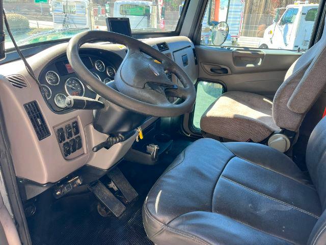 Peterbilt truck cab interior showing steering wheel, dashboard gauges, and driver seat.