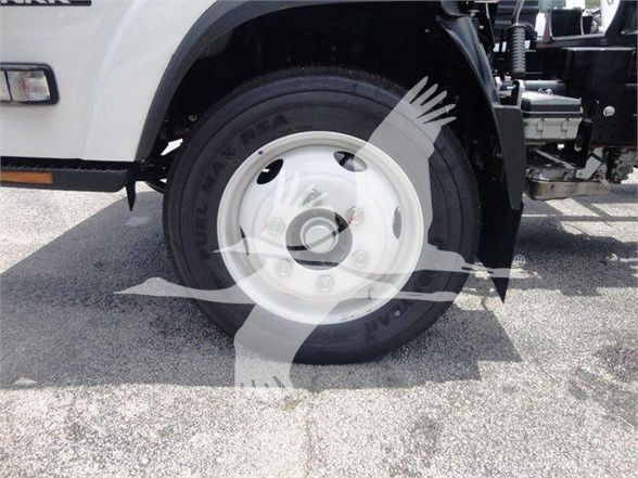 Isuzu NPRR/N RR front wheel showing steel wheel and tire with black sidewall; part of a tow truck chassis visible.