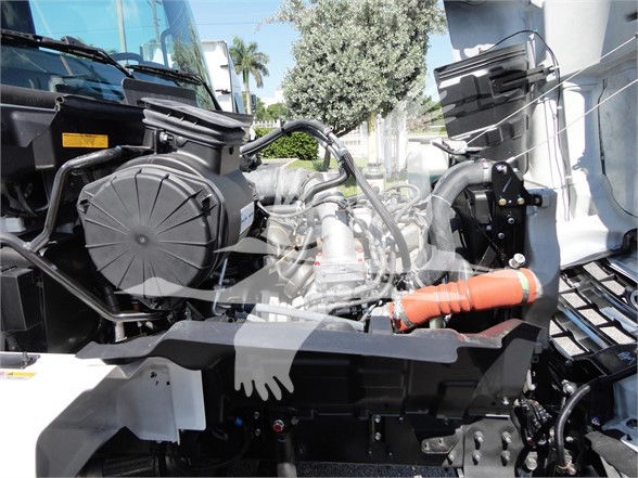 Hino 268A engine bay showing various hoses, radiator hoses, and components in view.