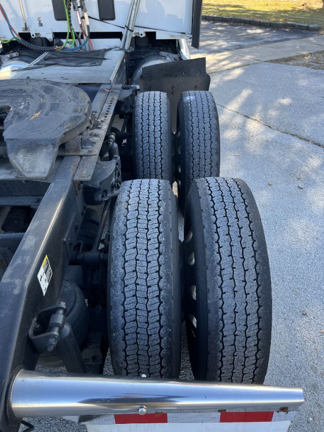 Peterbilt 579 chassis with dual rear axle tires visible, side view showing exposed frame and sleeper cab area.