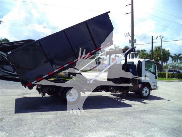 Isuzu NRR dump truck with bed raised, side view showing cab and chassis.