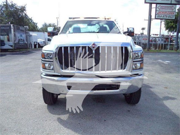 Front view of a white 2023 International CV truck with prominent chrome grille and bumper.