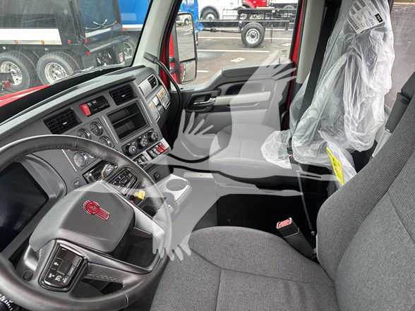 Interior of a 2026 Kenworth T880 truck cab showing steering wheel, dashboard, and driver seat.