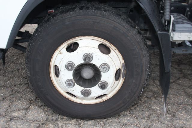 Isuzu NPR-HD wheel and tire with steel rim and lug nuts visible.
