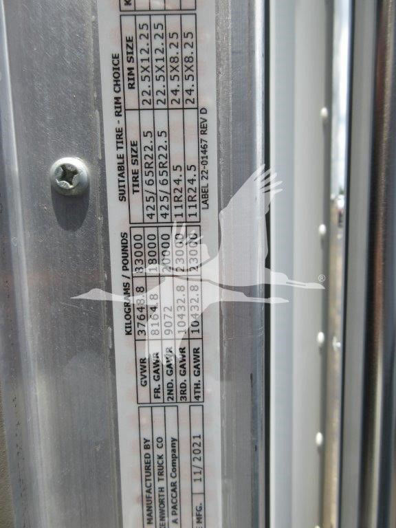 Vehicle door jamb label showing weight ratings and tire information for a Kenworth truck. Visible data includes GVWR, front axle weights, rear axle weights, tire sizes and pressures, and manufacture date.