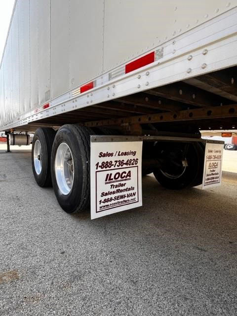 Trailer undercarriage showing dual rear axles and LOCA rental signage under CIMC COOL GLOBE trailer.