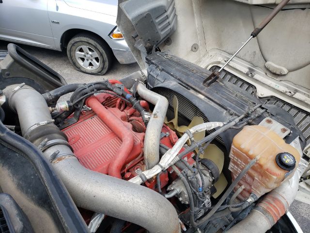 International PROSTAR engine bay showing red intake manifold, radiator, coolant reservoir, hoses, and engine components.