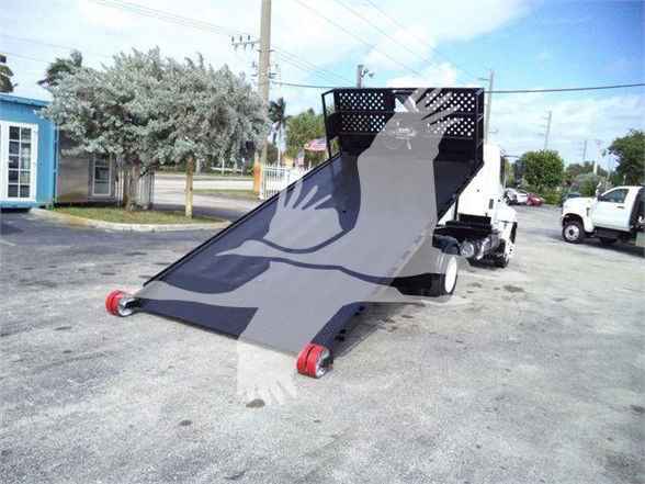 Hino 258LP hooklift truck with a lowered flatbed in a parking lot.