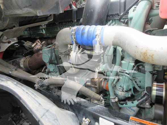 Volvo VNL64T740 engine bay showing turbo hoses and engine components.
