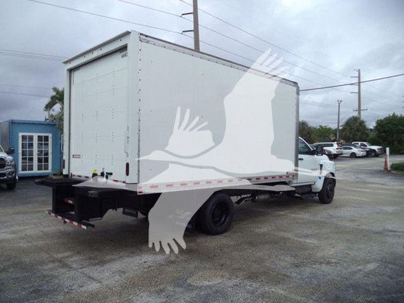 Box truck with a cargo box on a white Chevrolet Silverado 6500HD chassis, rear view showing empty box rear doors and rear bumper; logo watermark on image.