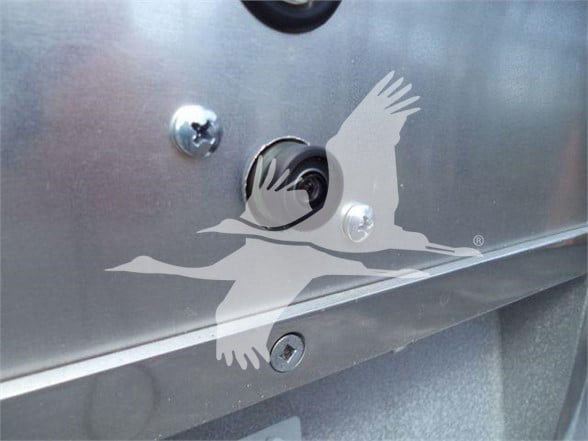 Ram 5500 SLT truck bed or tailgate area with a keyhole and metal panel; watermark of a flying bird logo overlays the image.