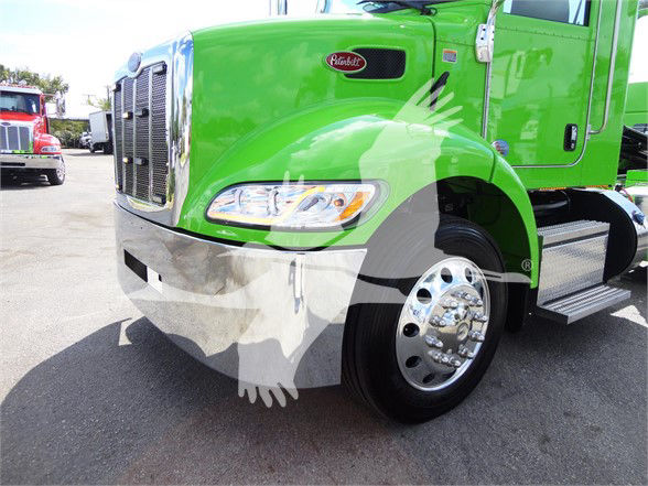 Front left side of a bright green 2022 Peterbilt 337 truck with chrome bumper, headlight, and wheel. Visible Peterbilt emblem on the hood.