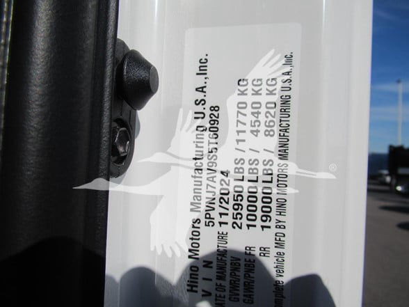 Label on vehicle door jamb with Hino Motors USA, Inc. manufacturing and weight specs including 10000 LBS, 19500 LBS, 4540 KG, 6820 KG, and other VIN-related text.