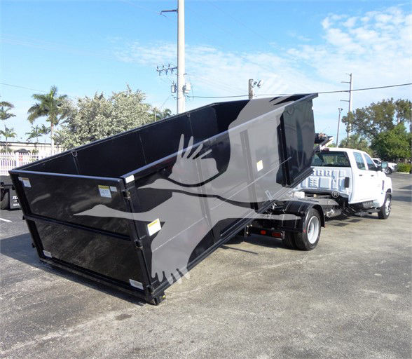 2023 Chevrolet Silverado 5500HD dump truck bed shown in a dealership lot with white cab and black dump body.