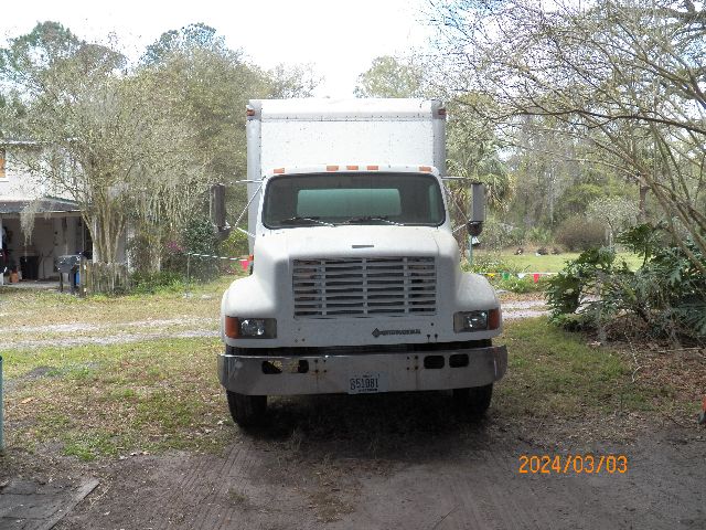 Front view of a white IC Corporation 4700 box truck with large grille, rectangular cargo box, headlights, and license plate. Date stamp 2024/03/03.