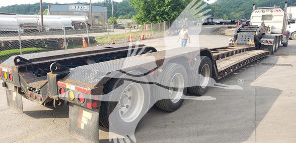 2018 Fontaine 55 Ton Drop Side Rail trailer showing long lowboy chassis, triple axle with side rails and rear lights.