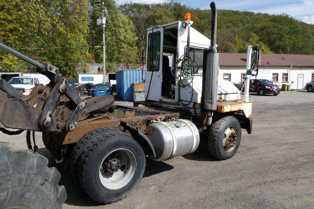 All-terrain yard truck 2007 Ottawa YT30 side view showing cab, fuel tank, and wheel axles.