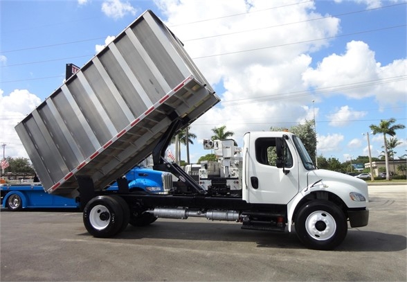 2014 Freightliner BUSINESS CLASS M2 106 with dump bed raised, white cab, single rear axle, in-service utility truck.