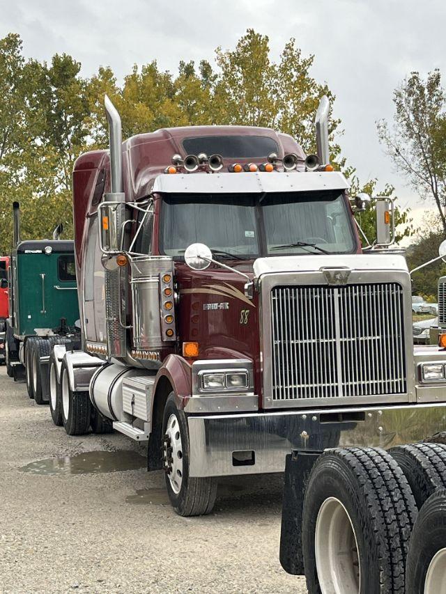 Tractor-trailer-style Western Star truck with chrome grille, maroon cab, dual exhaust stacks, and large front bumper.