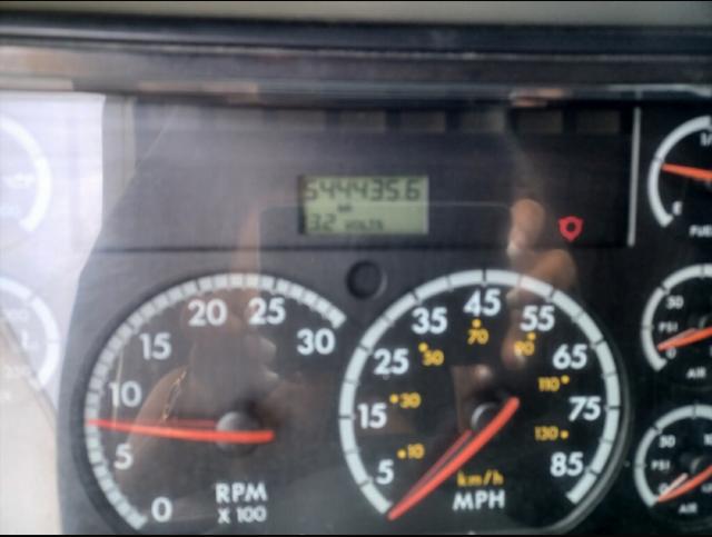Dashboard of a 2007 Freightliner Columbia showing tachometer, speedometer, and digital display with stock number 730295.