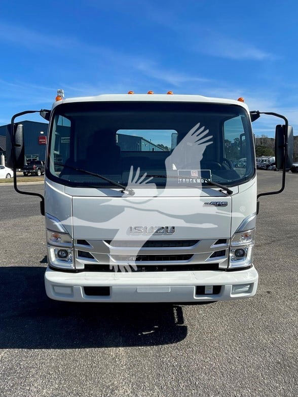 Isuzu NPR HD cab and chassis front view showing Isuzu emblem, daytime running lights, and front bumper. Clear windshield with large side mirrors.