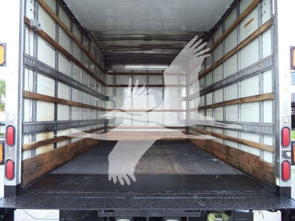 Isuzu NPR HD truck cargo area with empty box, interior walls with cross-slats, rear doors open showing wooden rails and metal floor.