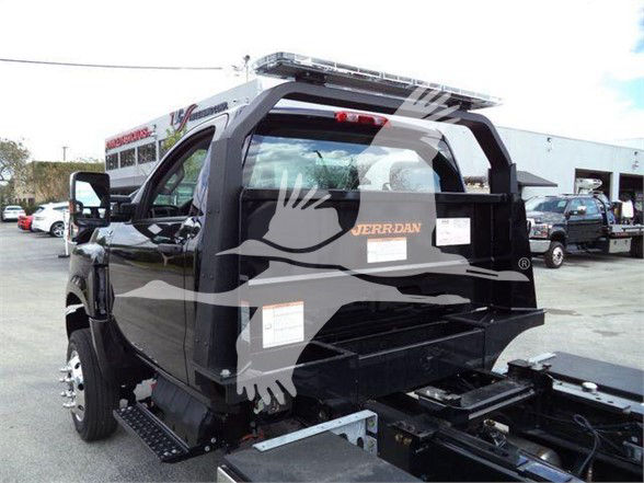 Truck cab rear showing Jerr-Dan storage box and tail end with deck, side mirrors, and rear bumper.
