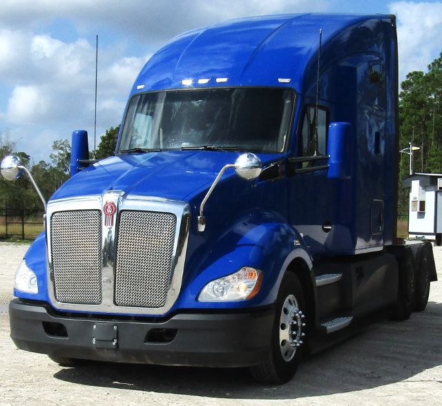 Kenworth T680 blue cab and chassis truck, front three-quarter view with chrome grille and aerodynamic cab