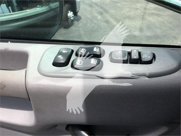 Peterbilt truck interior door panel with window control switches. Visible text on switches includes window controls icons; no legible part numbers.