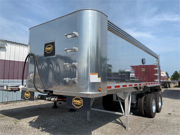 24ft aluminum dump trailer with top hinge doors, rear view showing hydraulic lines, MAC logo, and dual rear axles.