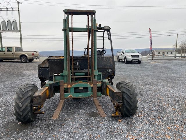 Kesmac F5000 forklift chassis/back view showing large front forks, green frame, black operator area, and rugged tires.