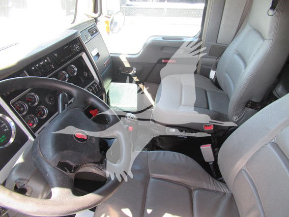 Kenworth W900L cabin interior showing steering wheel and front seats.