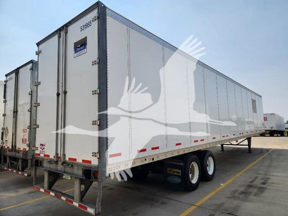 2019 Wabash trailer side view showing dual axle and white exterior with blue accents.