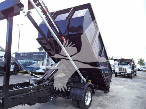 Truck bed with dump mechanism visible; no legible labels or fluid markings visible.