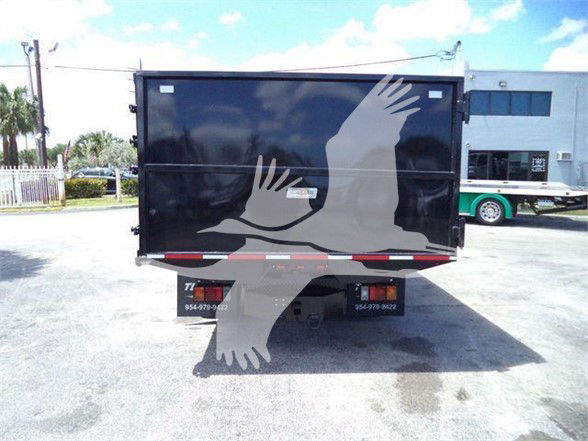 Isuzu NRR dump truck rear showing trailer with black doors and two contact numbers on bottom edge.