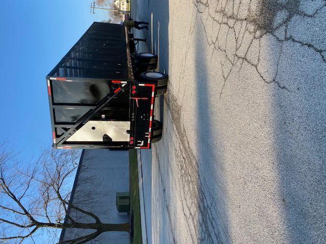 Transcraft 48 ft crush car carrier trailer from rear-right perspective in a parking lot.