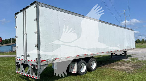 Visible side view of a Vanguard Vip Sheet & Post trailer with dual rear doors and tandem axles.