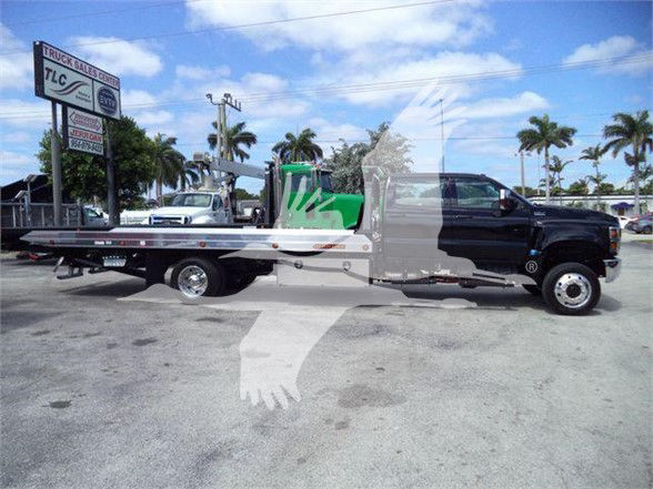 2023 International CV truck with tow bed shown in side profile, VIN 1HTKTSWK9PH419807.
