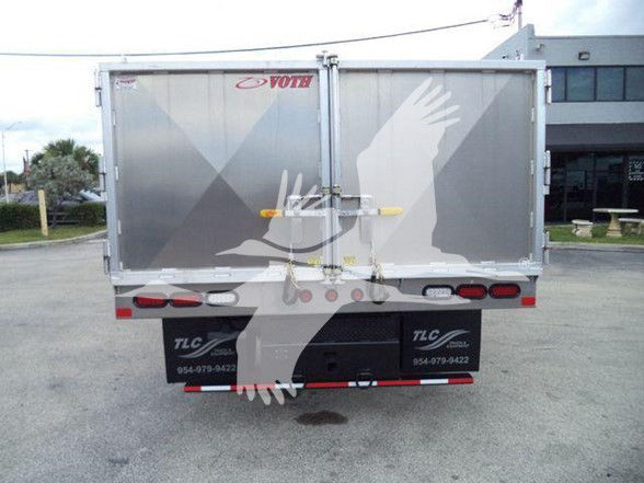 Chevrolet W4500 dump truck rear view with graphic winged hand logo on cargo doors.