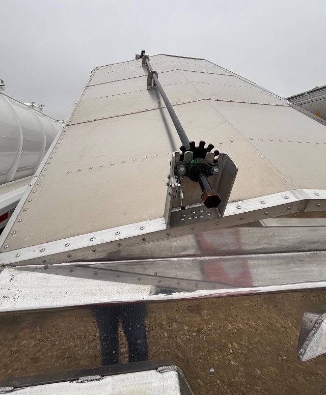 Aluminum hopper trailer top hatch with centerline auger/mechanical component and riveted panels.