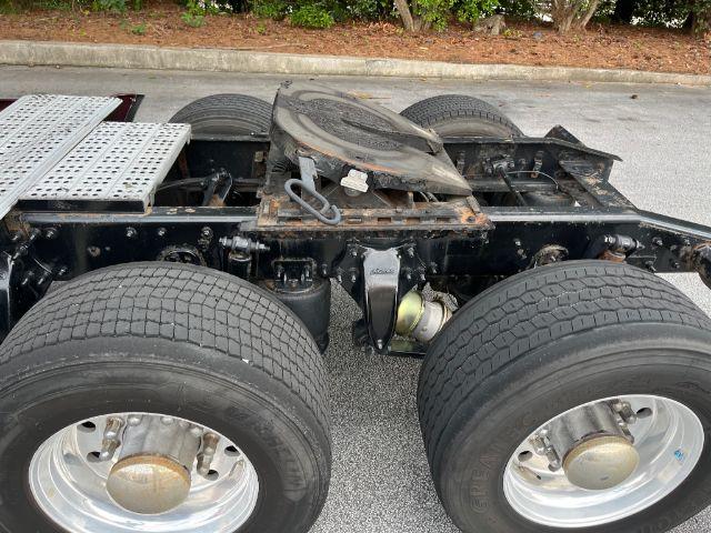 Freightliner Cascadia truck chassis showing rear dual axles and fuel/tank area with wheels and frame details.