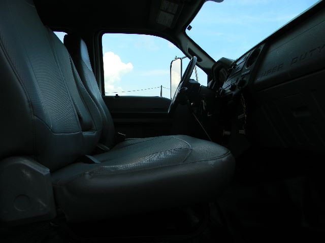 Ford F-750 Super Duty crew cab interior showing front seats and dashboard with steering wheel.