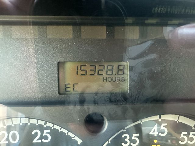 Dashboard displaying odometer reading 15328.8 hours with EC label; gauge markings visible.