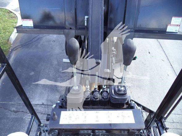 Cab view inside a Chevrolet Silverado 6500HD cab showing three gear/levers and control panel with labeled switches.