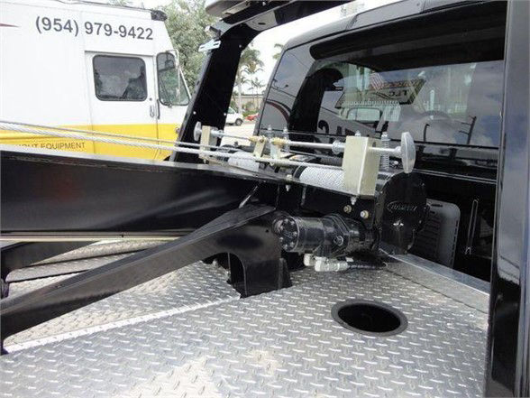 Ram 4500 truck bed showing a trailer hitch mount and safety device on diamond plate surface.