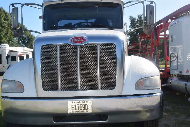 Peterbilt 337 front view showing large grille, headlights, chrome bumper, and Florida license plate E1769Q.