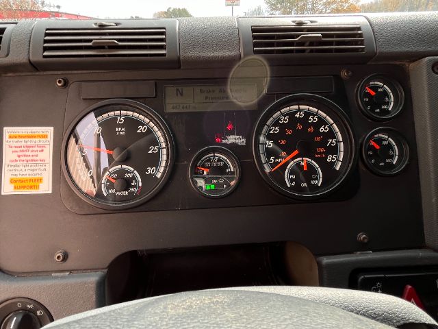 Dashboard of a 2019 Freightliner Cascadia 125 dump truck showing large gauges including tachometer, speedometer, and smaller indicators.